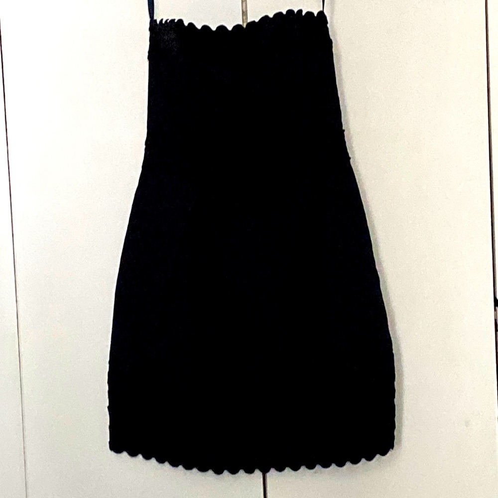 Black strapless dress with embroidered trim on neckline and around the skirt.